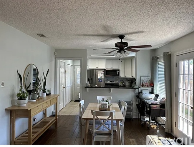A kitchen with a table and chairs in the middle of the room.