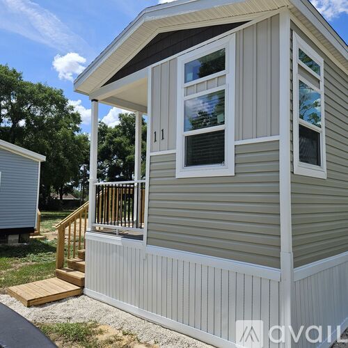 A small house with a porch and a covered entrance.