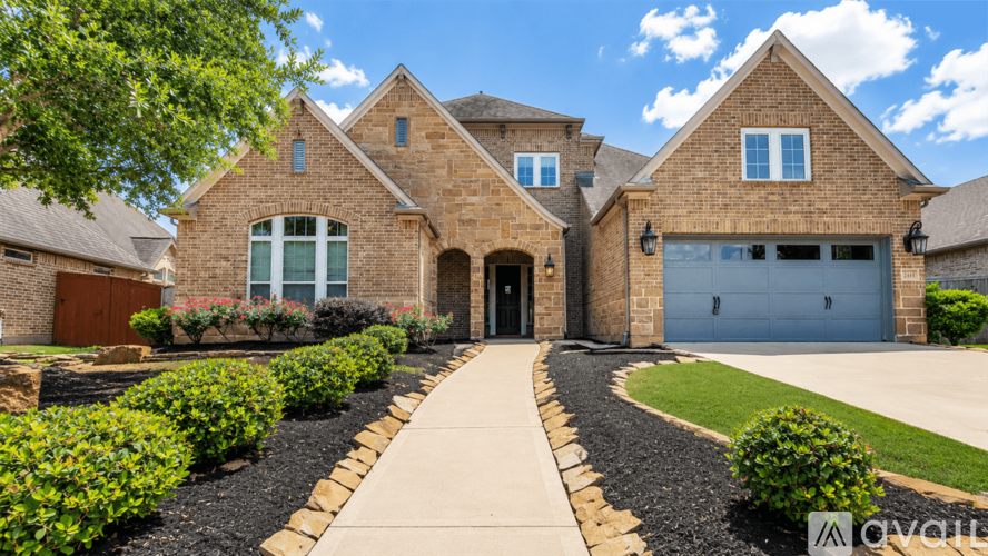 A large house with a driveway in front.