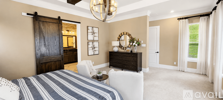A bedroom with a large bed and a wooden door.