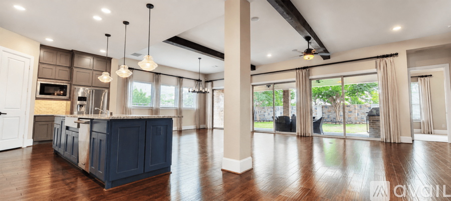 A spacious kitchen with dark blue cabinets and a large island.