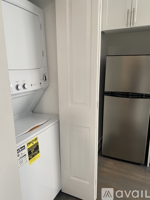 A white dishwasher and a stainless steel refrigerator in a kitchen.