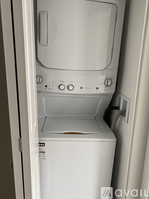 A white dishwasher with the door open is in the image.