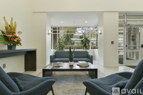 A living room with a grey couch and a coffee table.