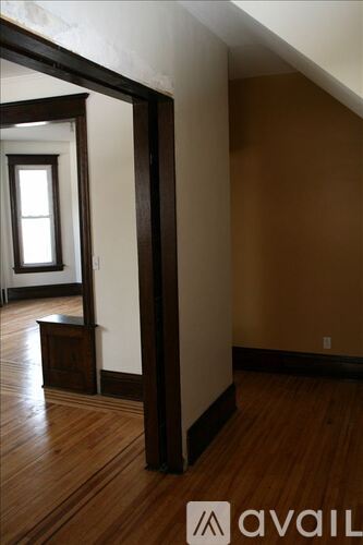 A room with wooden floors and a window.