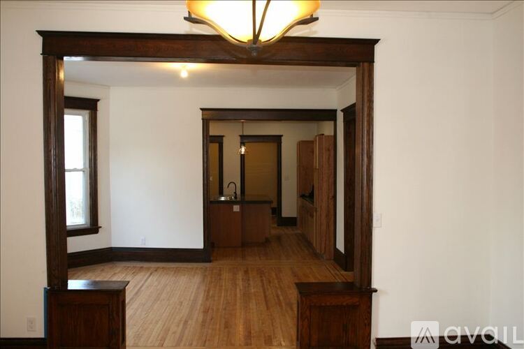 A room with wooden floors and a large mirror on the wall.