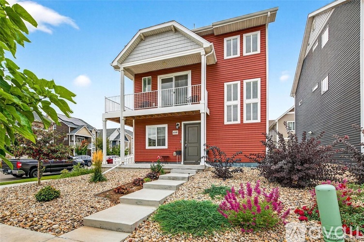 A red house with a white roof and a balcony.