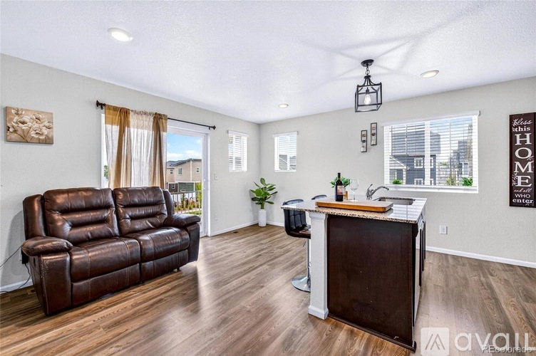 A living room with a brown leather couch and a wooden coffee table.