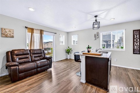 A living room with a brown leather couch and a wooden coffee table.