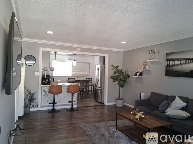 A living room with a grey couch and a wooden coffee table.