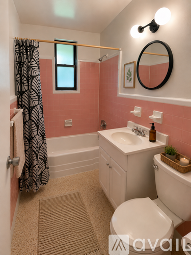 A bathroom with pink walls and a white toilet.