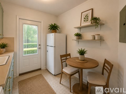 A kitchen with a table and chairs and a refrigerator.