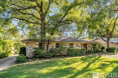 A house with a tree in front of it.