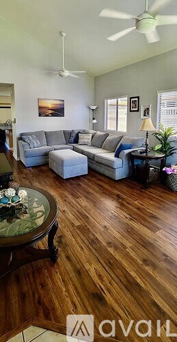 A living room with a grey couch and a coffee table.