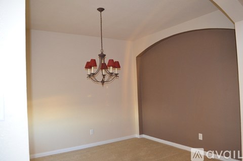A room with a chandelier hanging from the ceiling.