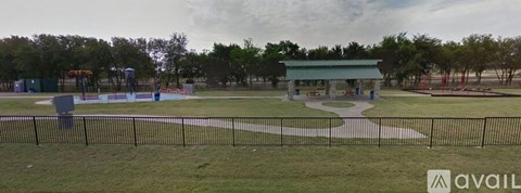 A park with a playground and a pavilion.