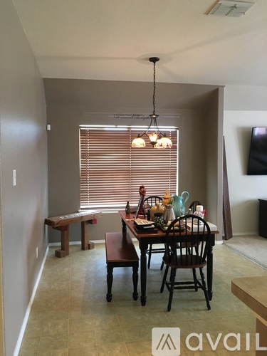 A dining room with a table set for four.