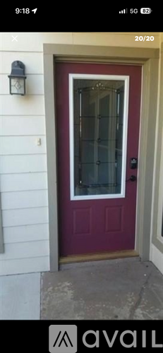 A red door with a glass window and a black handle.