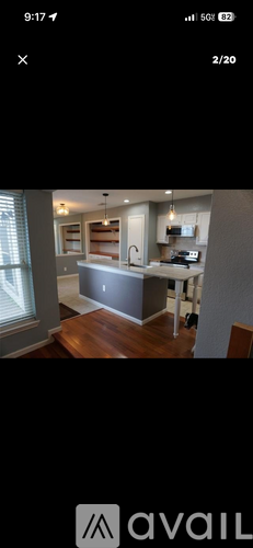 A modern kitchen with wooden floors and a large island.