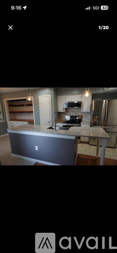 A kitchen with a countertop and a stove top oven.