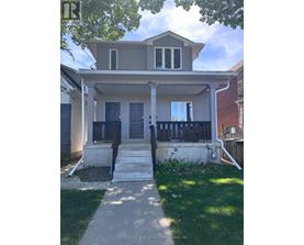 A house with a front porch and a black door.