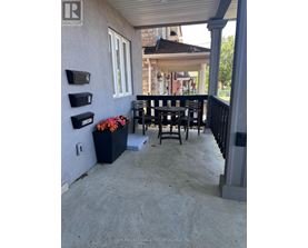 A patio with a table and chairs and mailboxes on the wall.