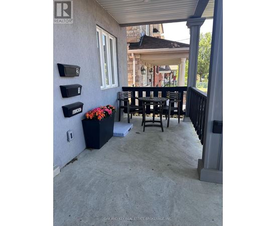 A patio with a table and chairs and mailboxes on the wall.