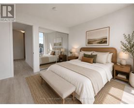 A bedroom with a large bed and a painting on the wall.