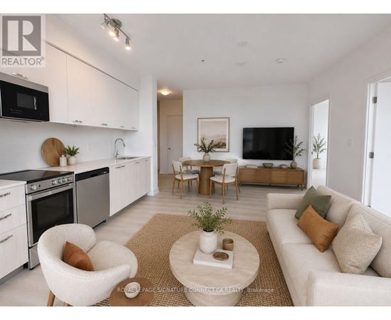 A modern living room with a white sofa, a coffee table, and a kitchen area in the background.