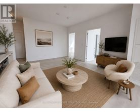 A living room with a beige sofa, a coffee table, and a television.