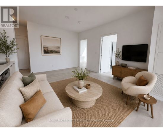 A living room with a beige sofa, a coffee table, and a television.