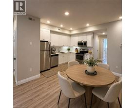 A modern kitchen with a dining table and chairs.