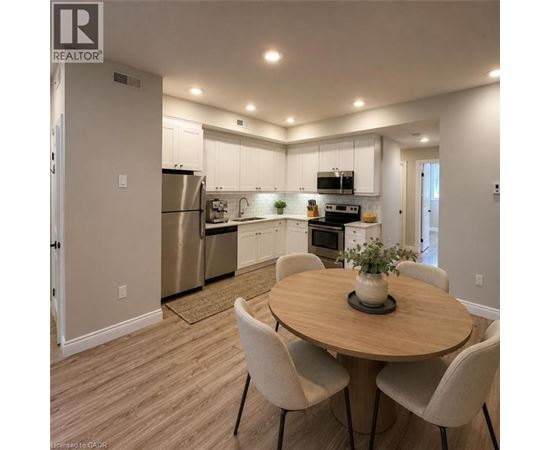 A modern kitchen with a dining table and chairs.