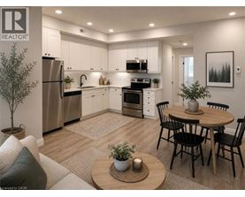 A well-lit kitchen with a dining table set for four.