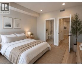 A bedroom with a large bed and a small tree.
