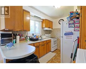 A kitchen with wooden cabinets and a white refrigerator.