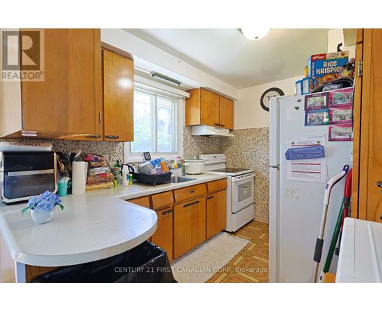 A kitchen with wooden cabinets and a white refrigerator.