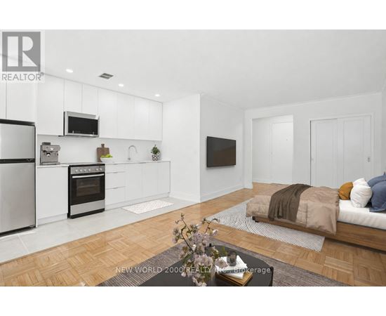 A modern kitchen with white cabinets and stainless steel appliances.