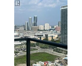 A cityscape with a mix of modern and older buildings, viewed from a high vantage point.