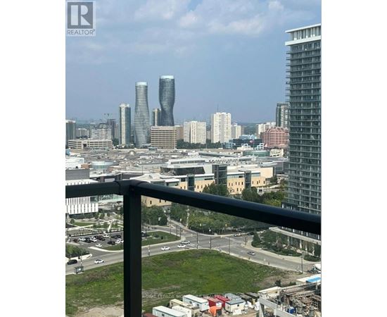 A cityscape with a mix of modern and older buildings, viewed from a high vantage point.