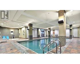 A large indoor swimming pool with a tiled floor and a metal ladder.