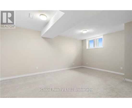 A room with a window and a ceiling light.