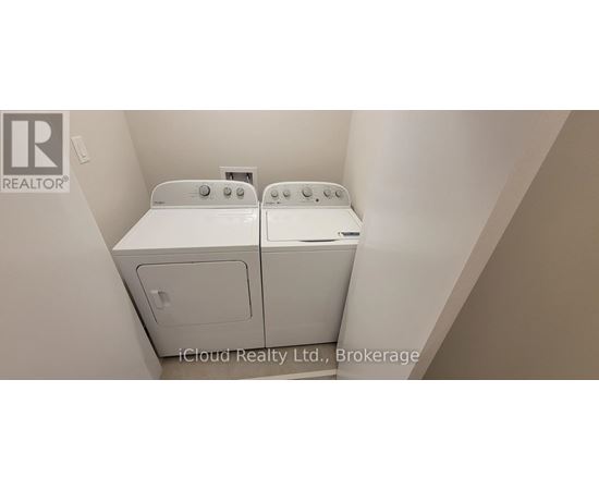 A white dryer and washer in a small laundry room.