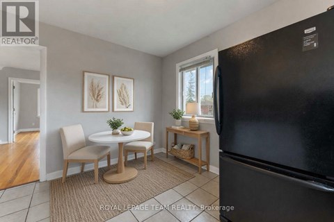 A kitchen with a table and chairs in the middle of the room.