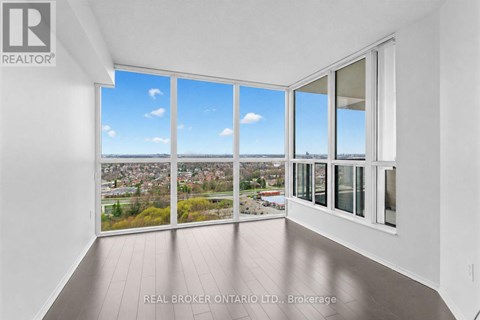 A real estate office is showcasing a property with a large window overlooking a city.