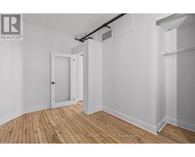 A white room with a door and a window.