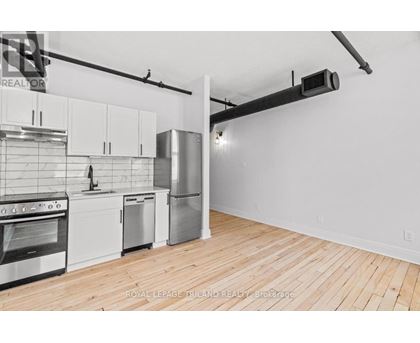 A kitchen with white cabinets and stainless steel appliances.