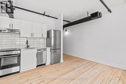 A kitchen with white cabinets and stainless steel appliances.