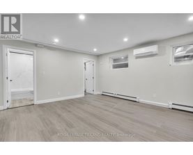A spacious room with a door on the left and a window on the right.