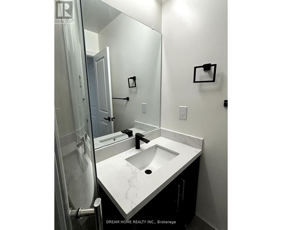 A bathroom with a marble sink and a mirror.